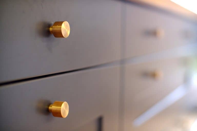 Sleek dark wood cabinet small brass modern knobs