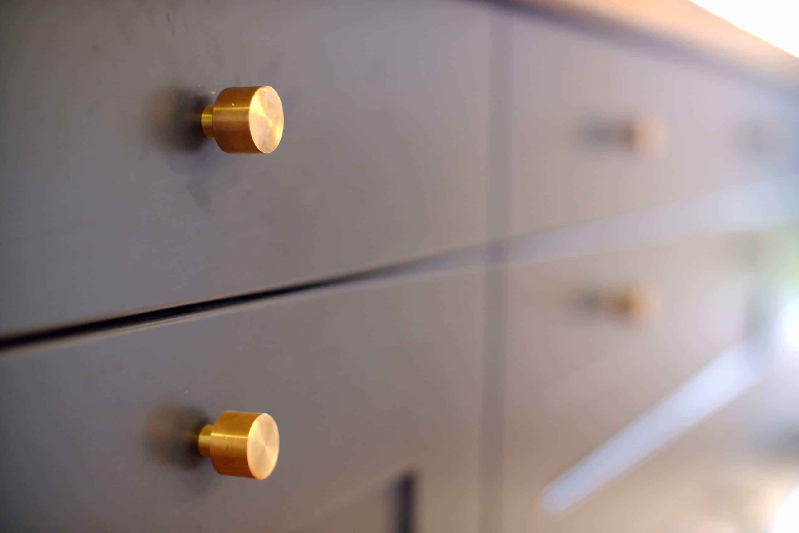 Sleek dark wood cabinet small brass modern knobs